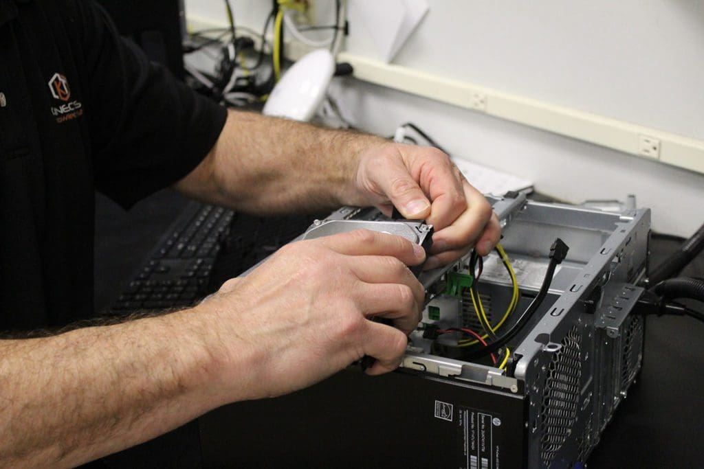 Technician connecting a hard drive to the computer