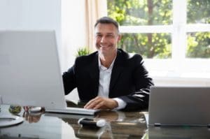 man working on computer smiling
