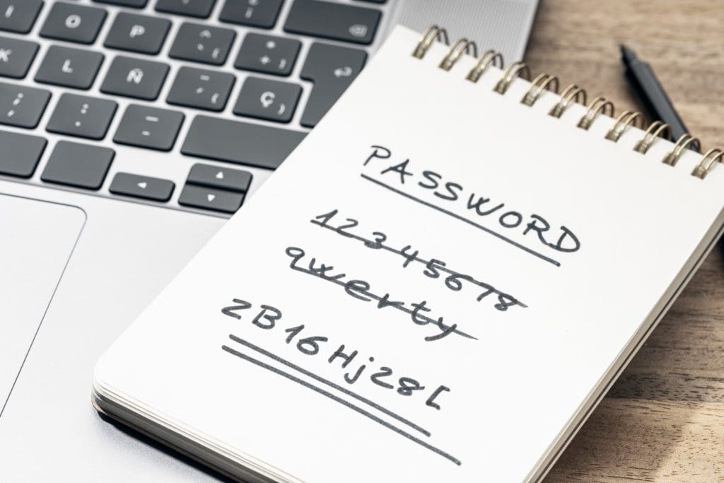 Strong and weak easy Password concept. Handwritten text on notepad on laptop