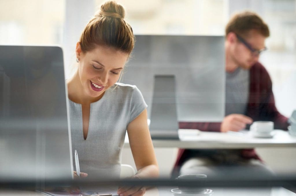 woman sitting at computer smiling