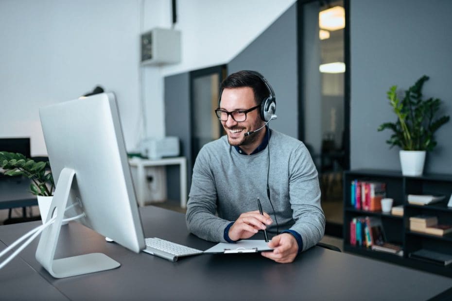 man at computer with headset