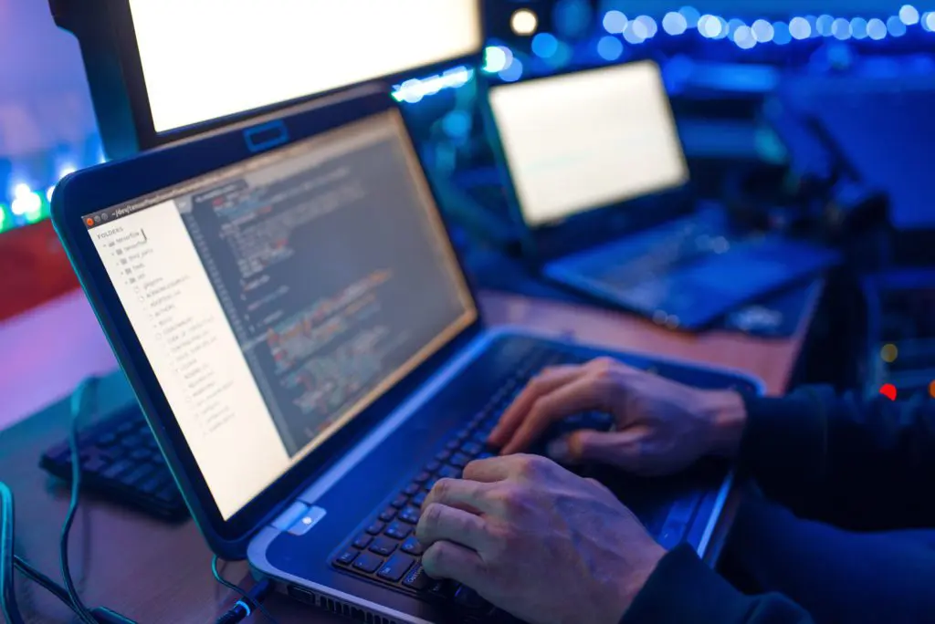 programmer typing code to update cybersecurity