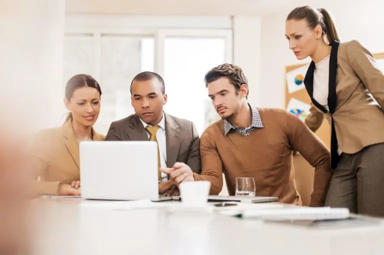 Business team reviewing data on computer