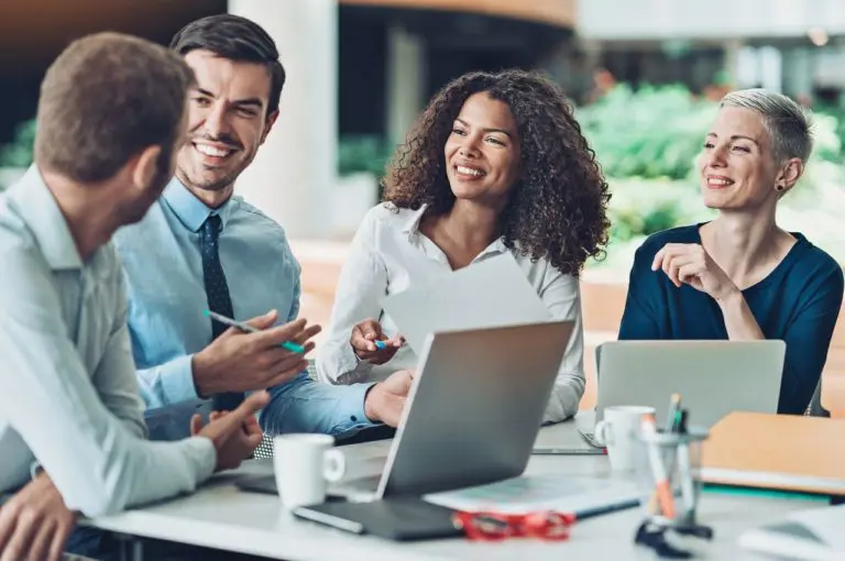 Employees working as a team utilizing computers