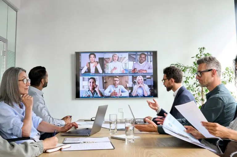 Business team utilizing smart classroom for client meeting