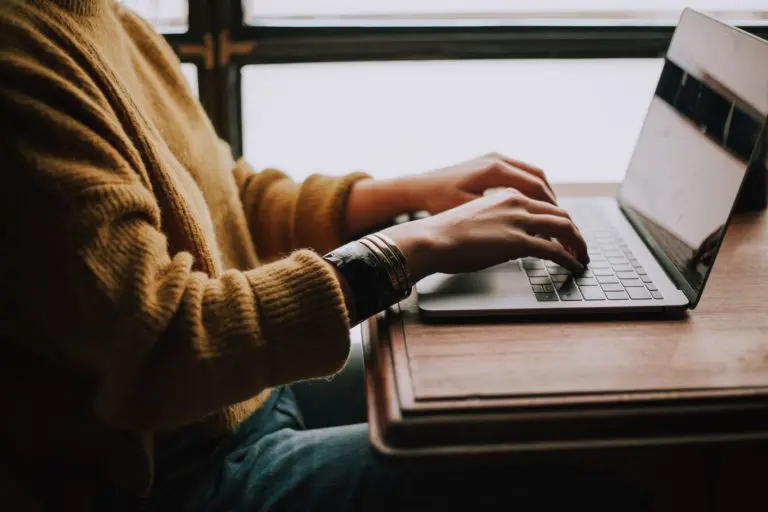 Person working on a laptop in a coffee shop