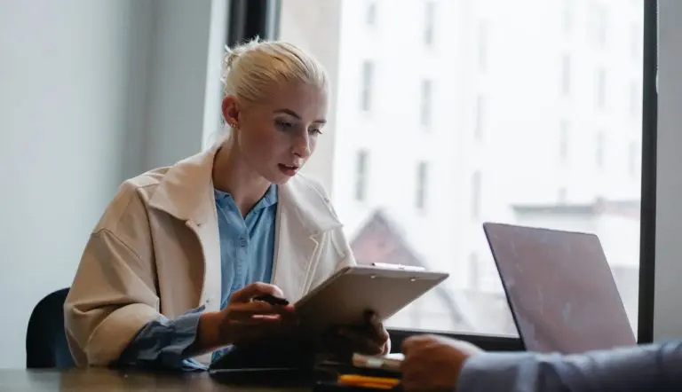 Woman going through IT checklist with Managed Service Provider