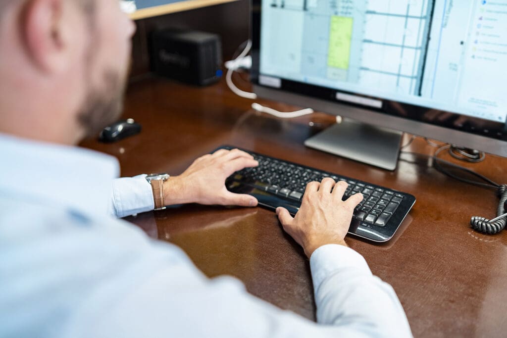 Business owner reviewing user accounts on his network