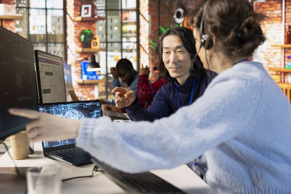 Coworkers-discuss-new-AI-implementation-in-their-IT