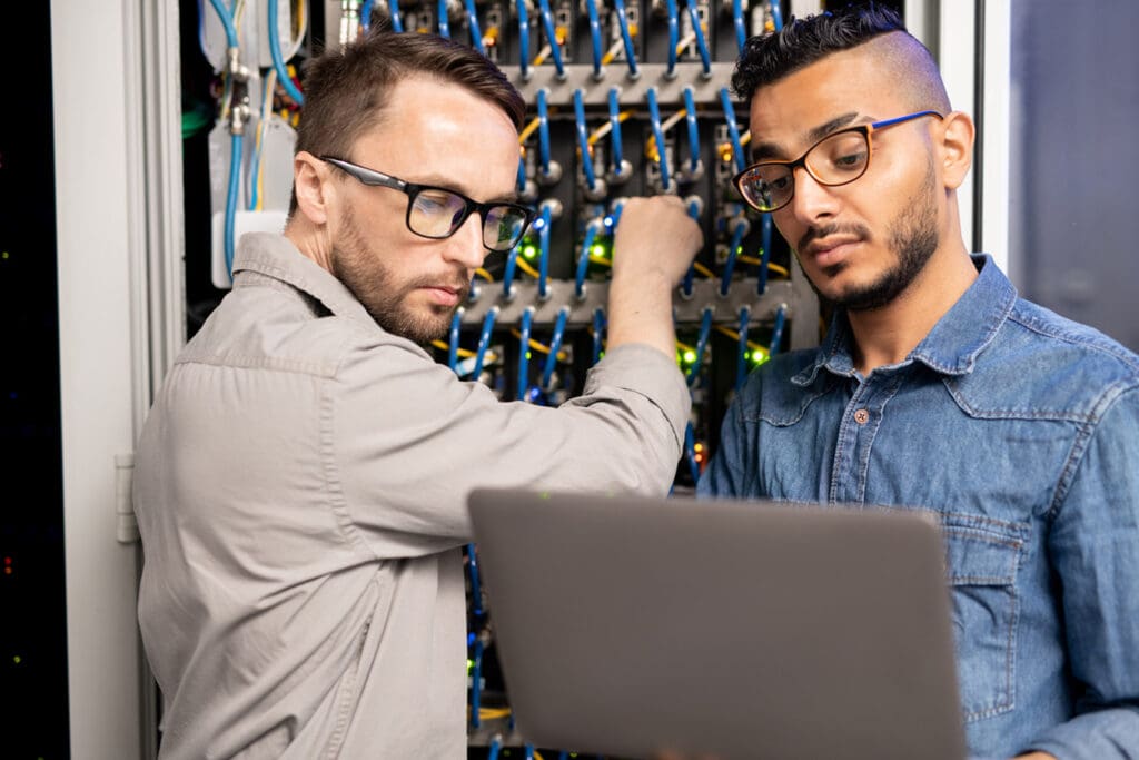 Two tech employees check server and perform maintenance