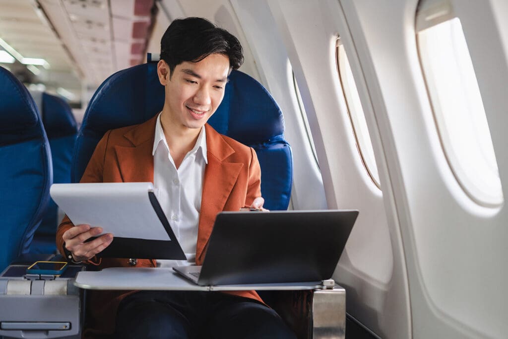 employee-working-on-laptop-inside-airplane-to-meet-deadline